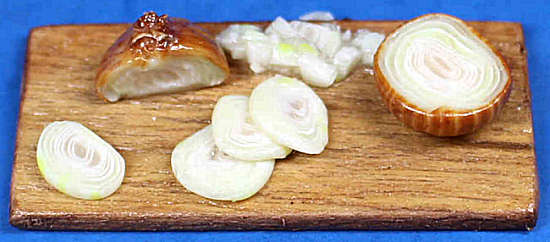 Slicing onion on board