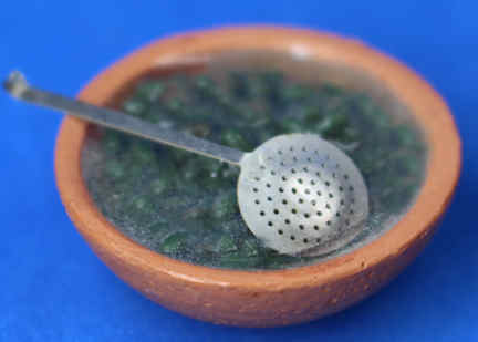(image for) Olives and ladle in a terra cotta bowl