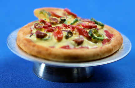 (image for) Pizza on metal pedastal dish - slice being removed